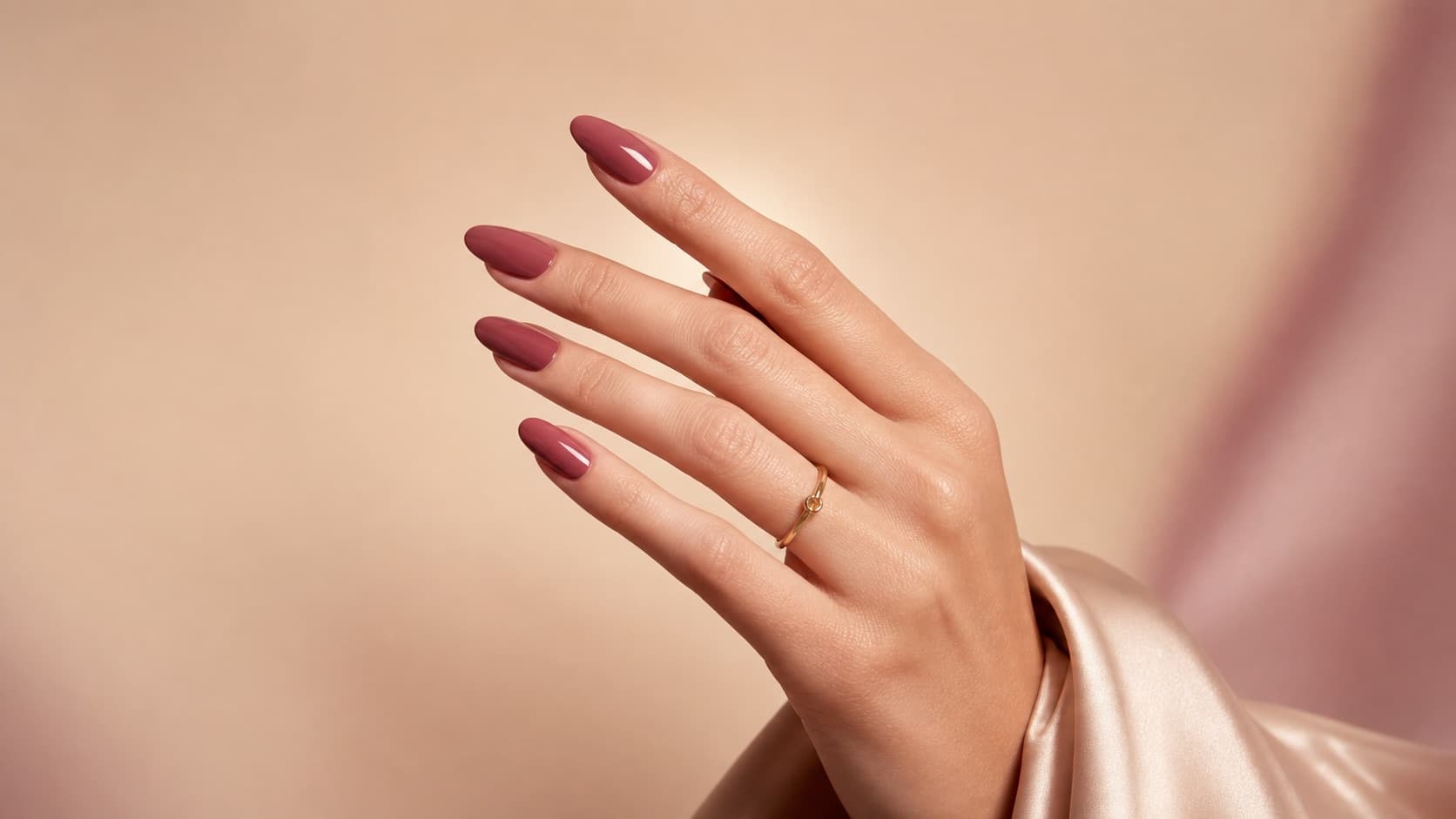 Editorial placeholder of glossy berry nails on an elegant hand